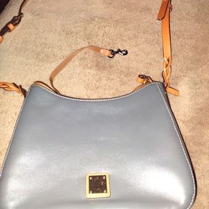 Dooney & Bourke Bag. 10 inch width & 7.5 length. Gray in color.